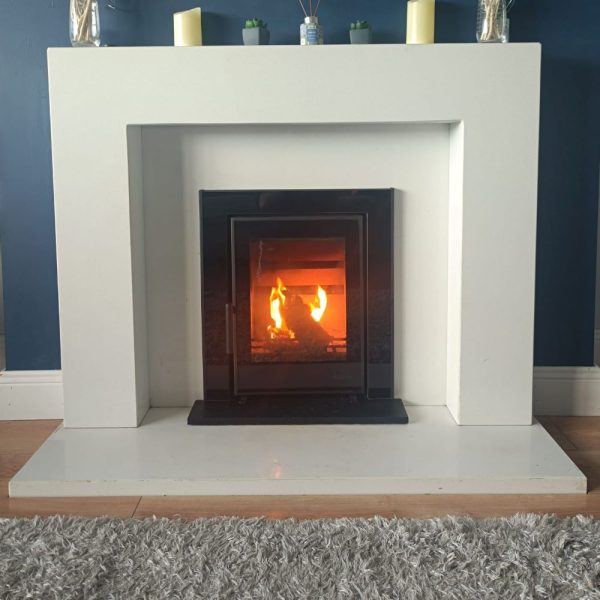 Atlantic Wave 5 insert stove mounted to a white marble lighting fireplace